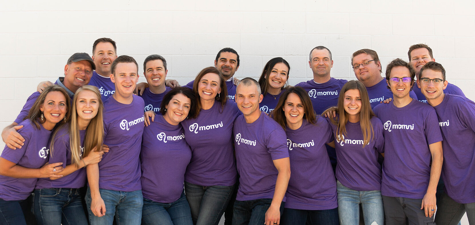 The original Momni team in purple momni shirts
